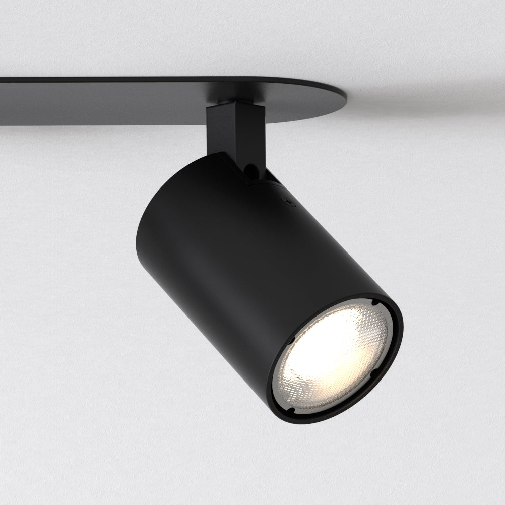 Black cylindrical ceiling spotlight with a textured light bulb