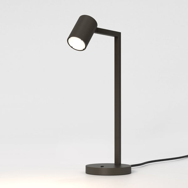 Bronze desk lamp with a cylindrical head and a rectangular arm on a round base