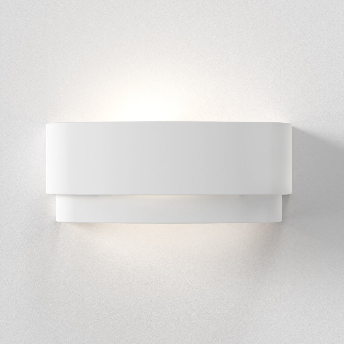 White wall light with two horizontal panels, casting light upwards and downwards on a textured white wall