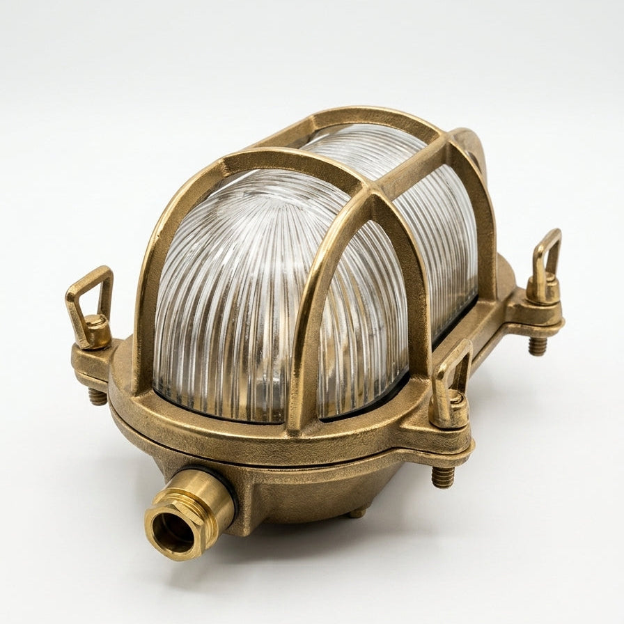 Nordlux Helford brass bulkhead wall light with ribbed glass shade and protective cage
