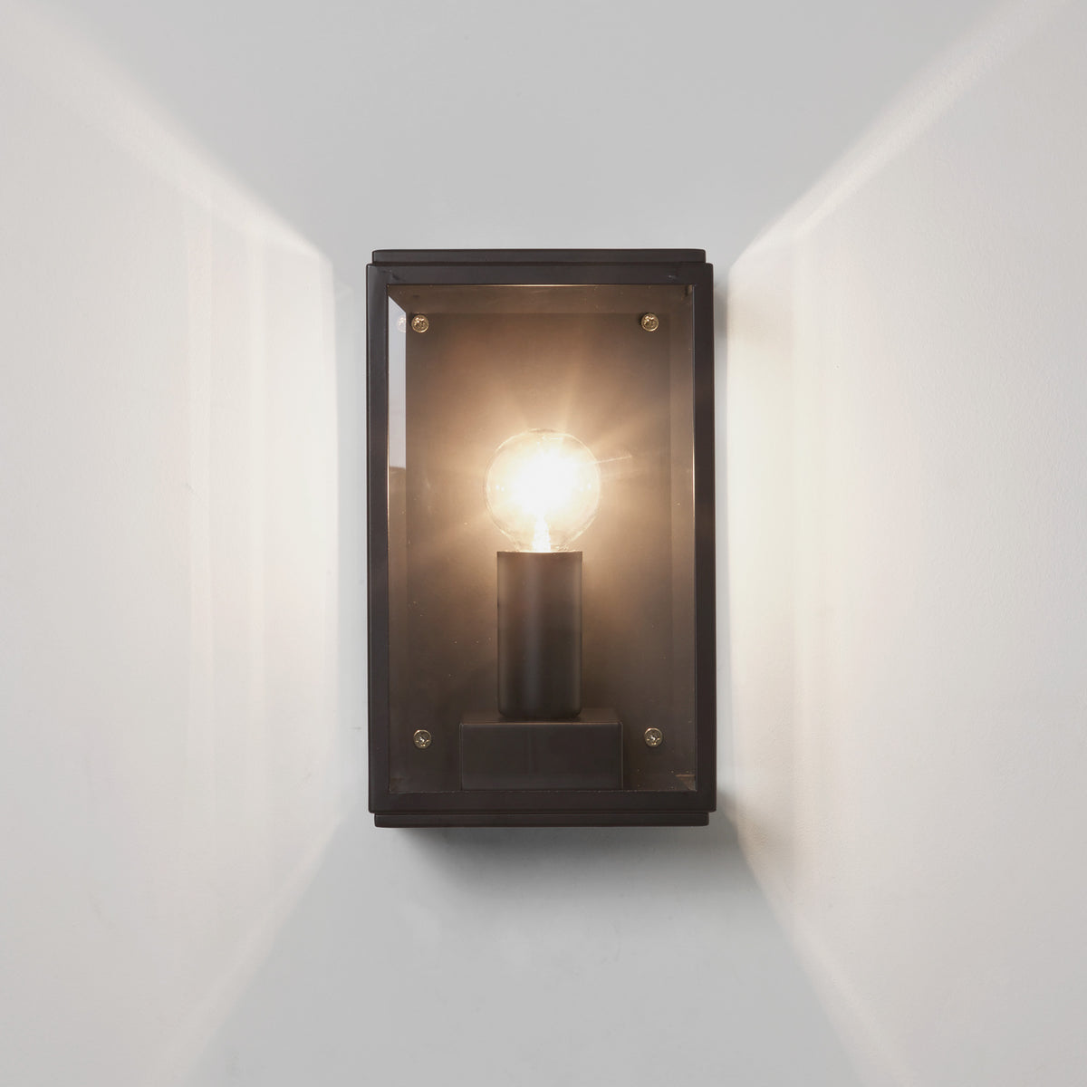 Black rectangular outdoor wall light with a clear glass shade and a visible bulb