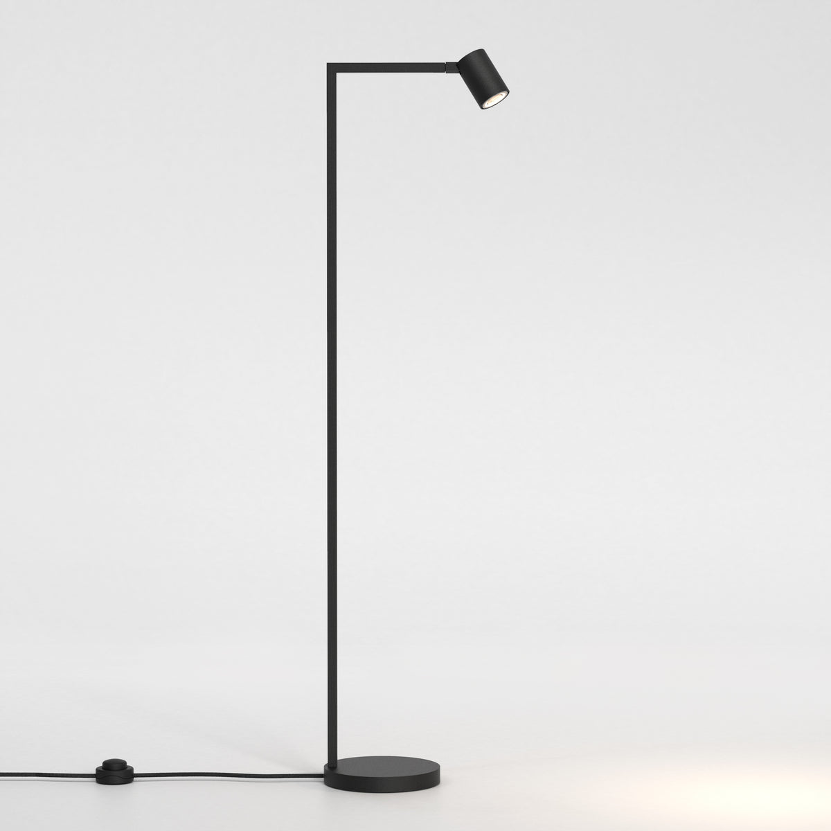 Black floor lamp with a thin vertical stand and a horizontal arm holding a cylindrical light head