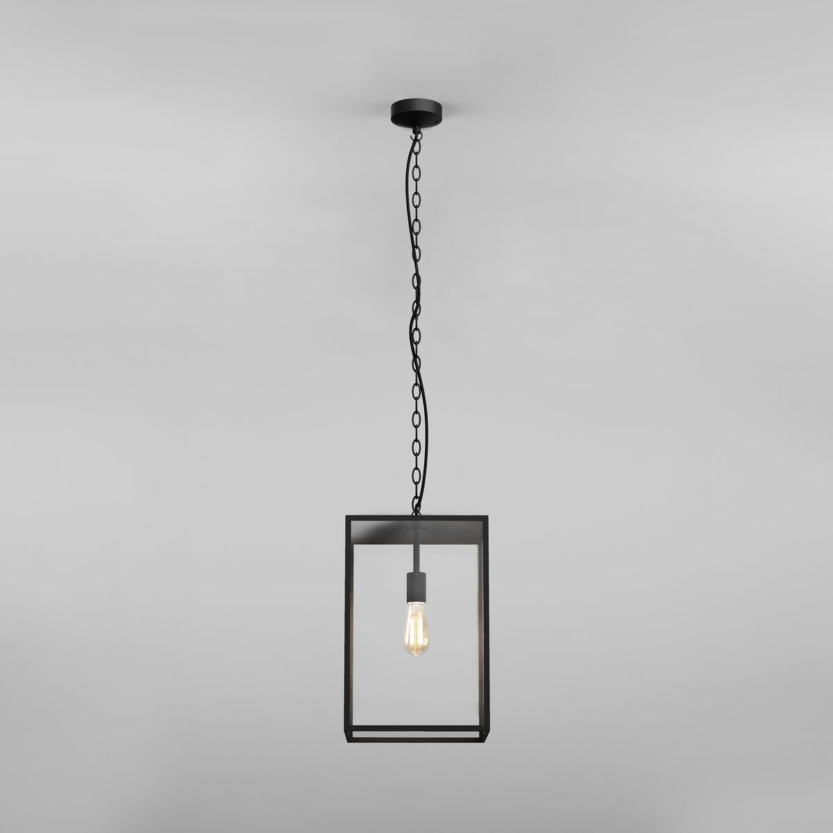 Black metal framed pendant light with a clear glass shade and exposed filament bulb