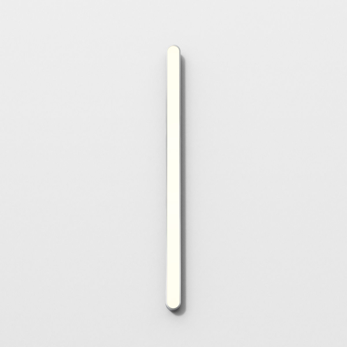 Vertical white light bar on a white wall