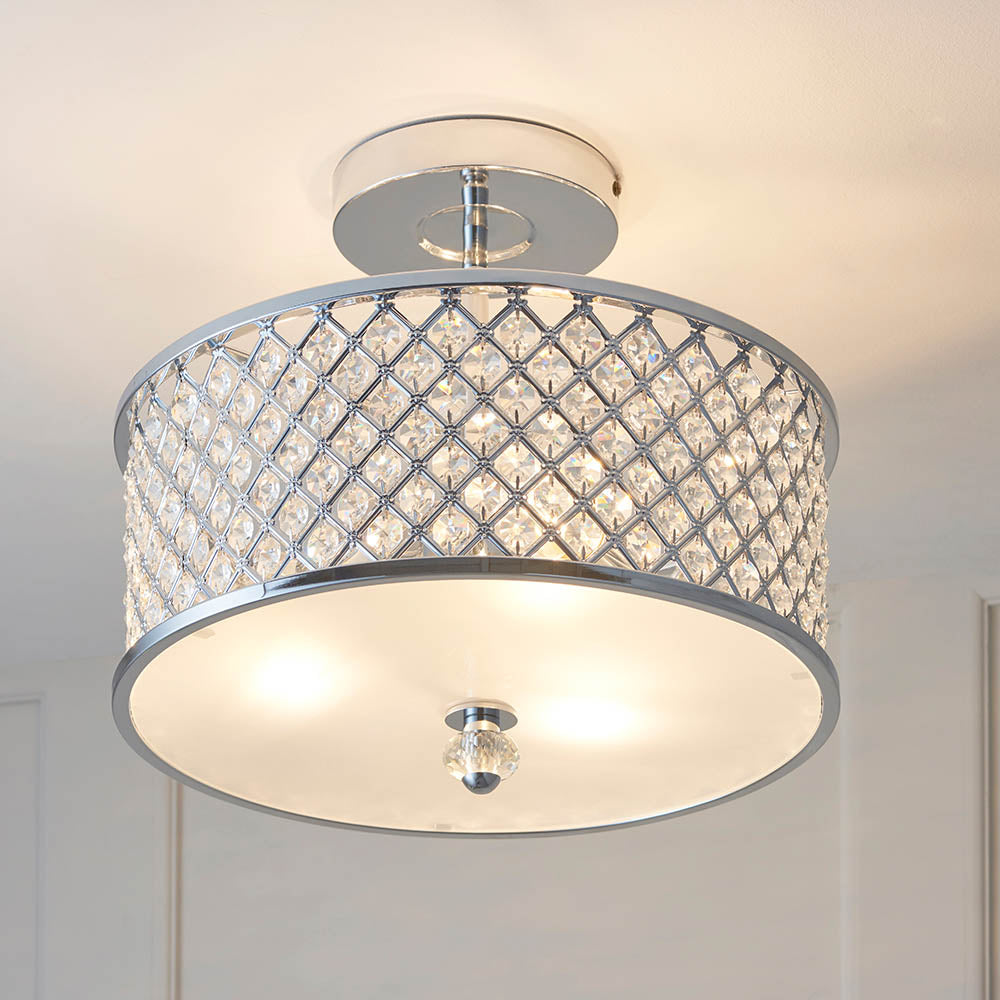 A semi-flush ceiling light with a chrome frame and crystal-studded drum shade casts a warm glow.