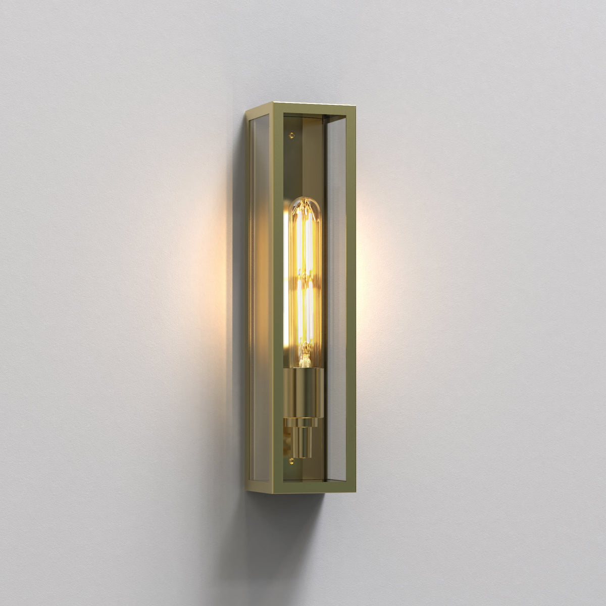Brass wall sconce with a rectangular frame and a visible filament bulb