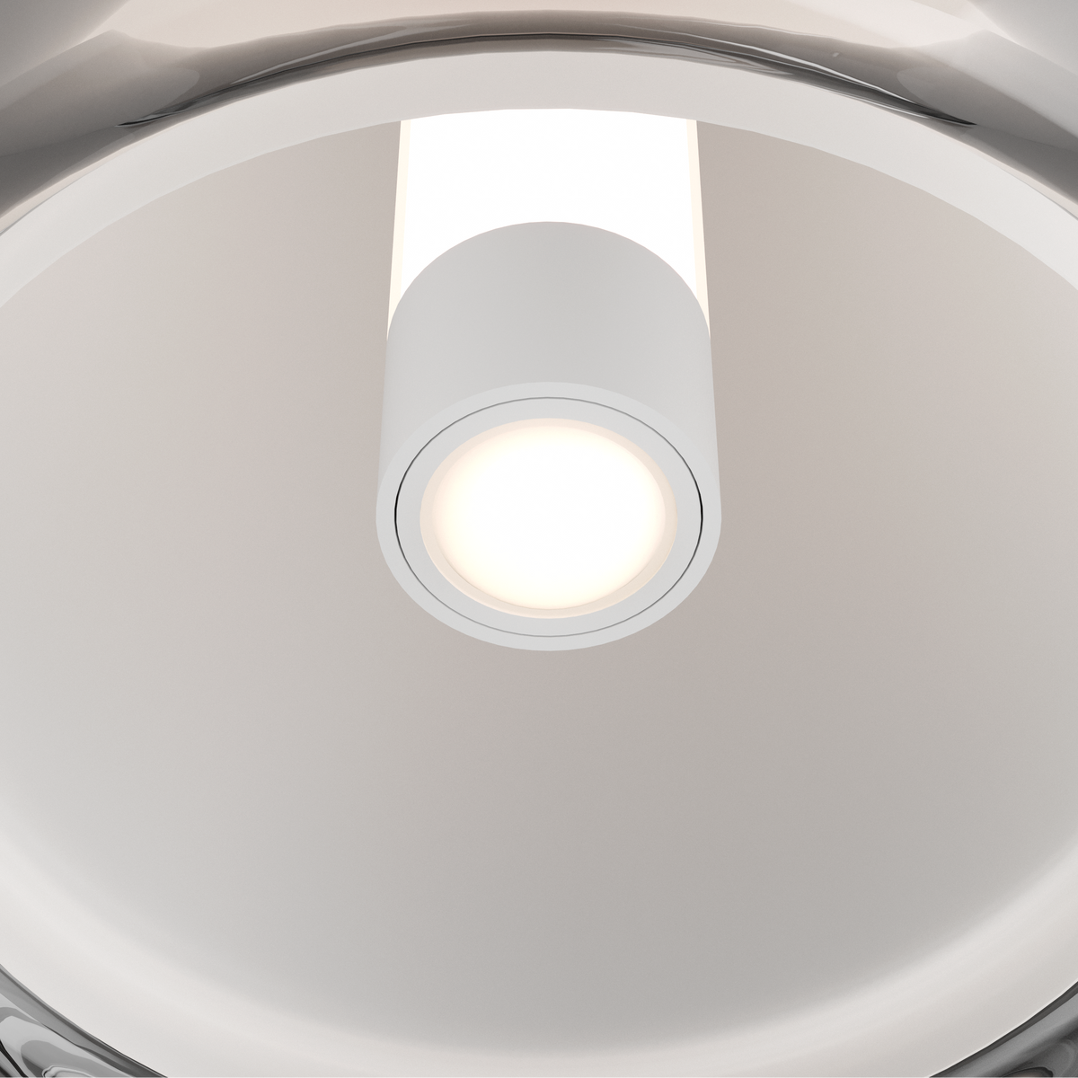 Close up of a white cylindrical light fixture with a bright, warm light emanating from its center