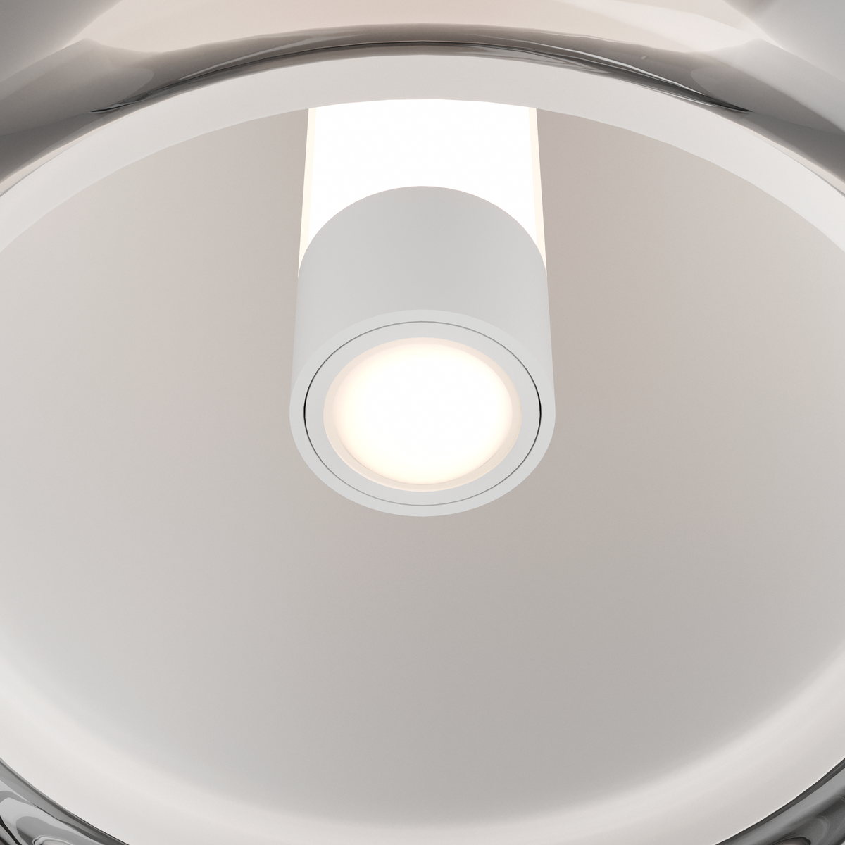 Close-up of a white cylindrical light fixture with a glowing bulb, surrounded by a reflective, curved surface