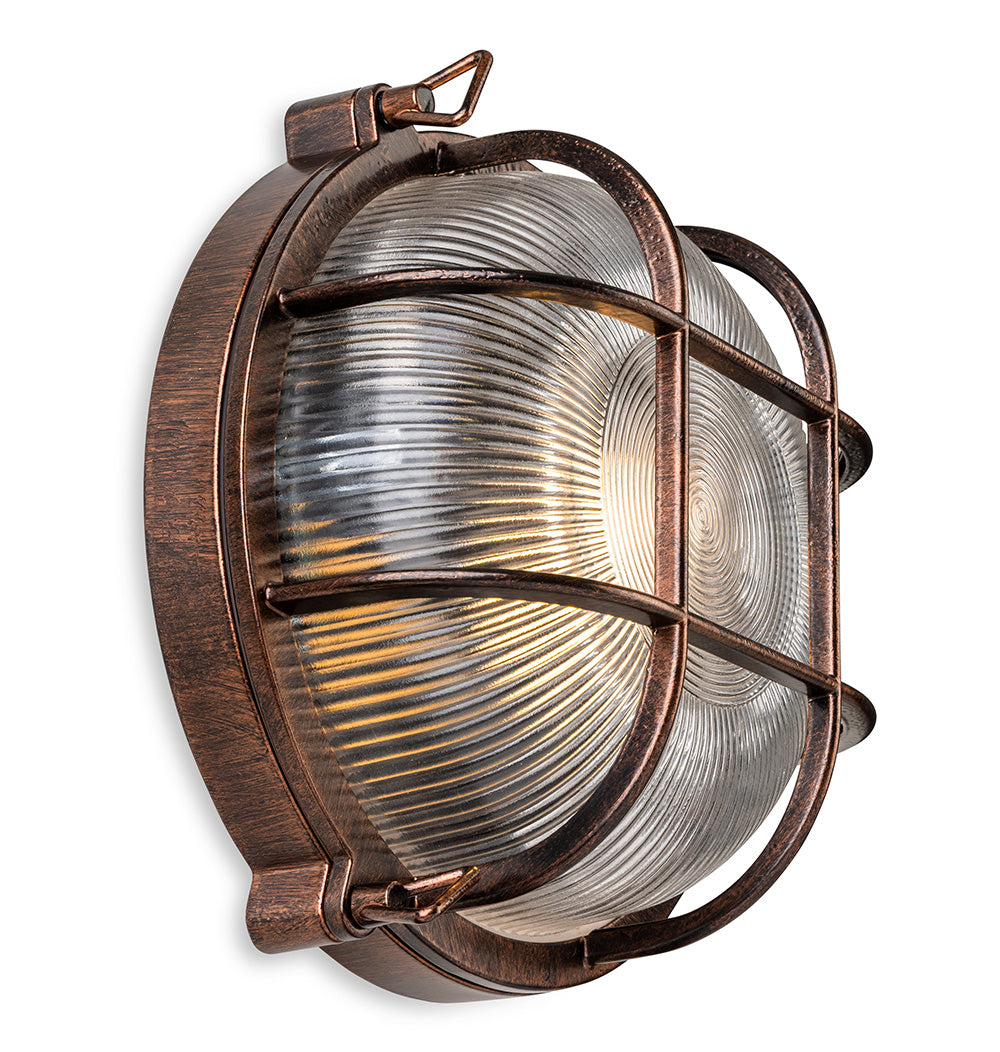 Round bulkhead light with a bronze finish and a ribbed glass diffuser