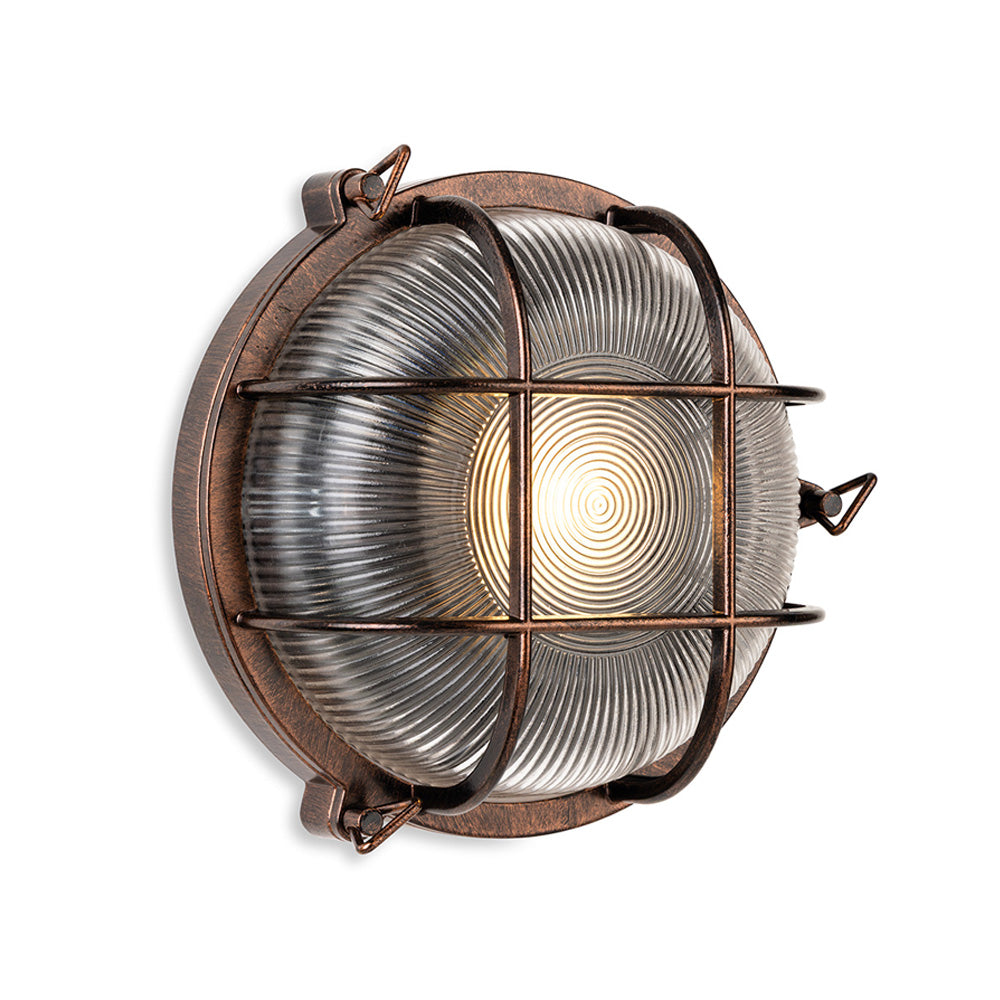 Round bulkhead light with a bronze finish and a ribbed glass diffuser