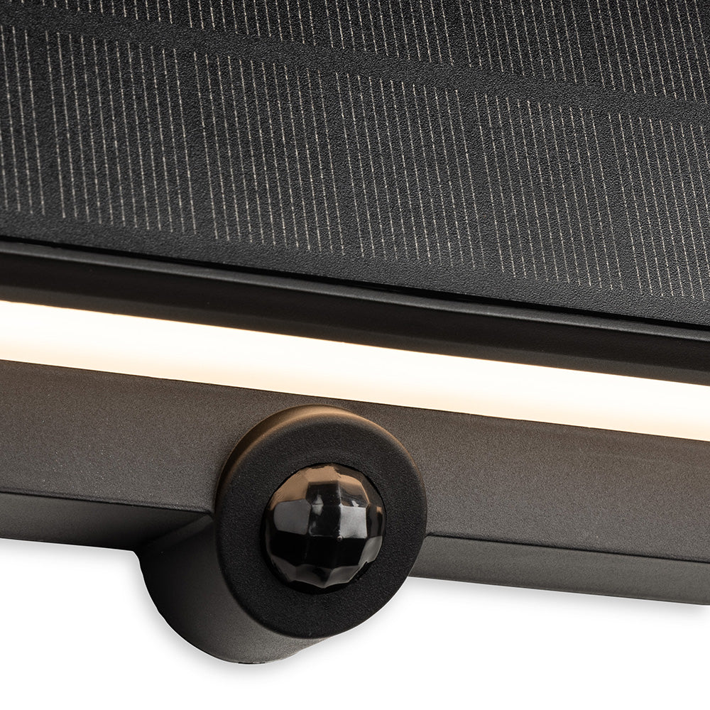 Close up of a black solar panel with a light strip and a motion sensor