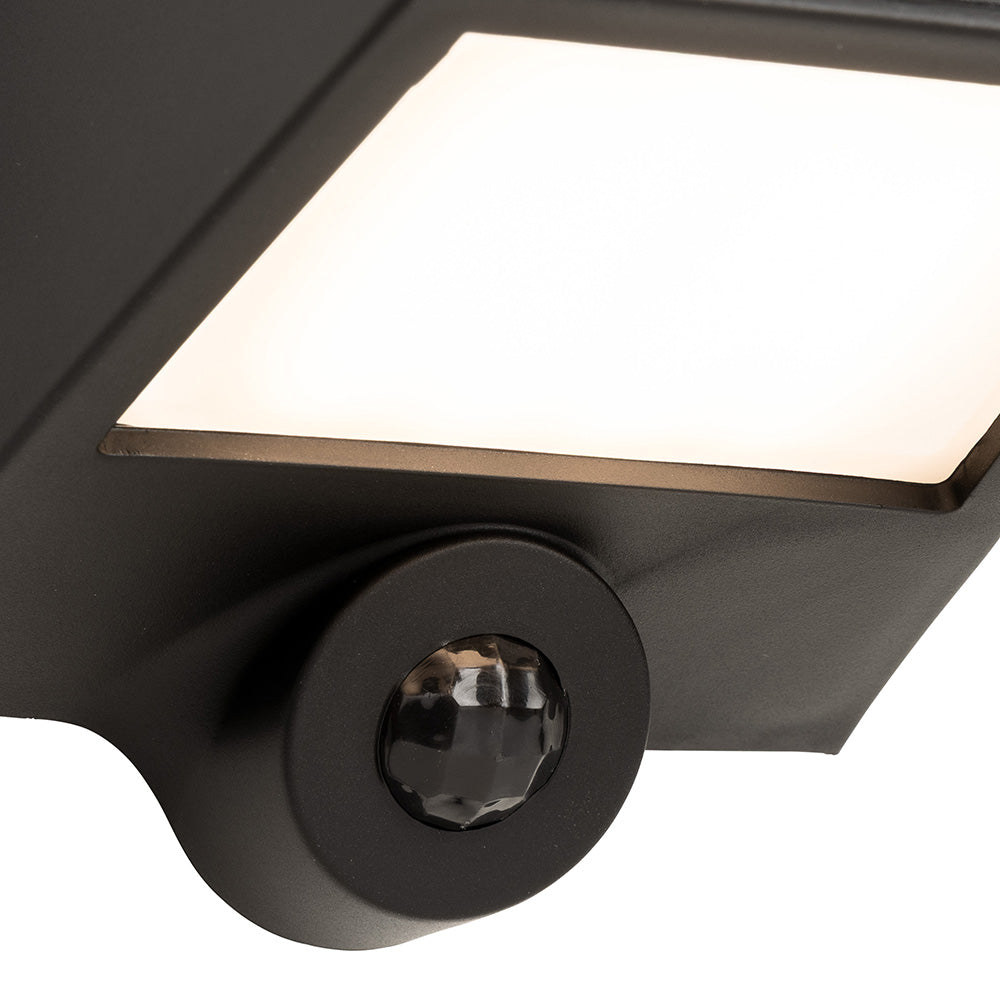 Close up of a black outdoor wall light with a motion sensor