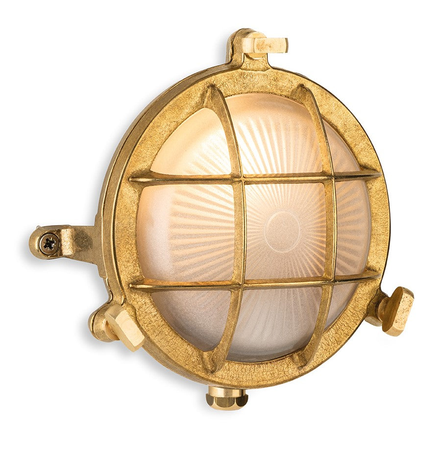 Round brass bulkhead light with a frosted glass diffuser and a protective cage