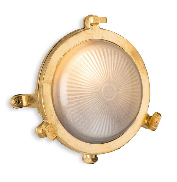 Round brass nautical wall light with a frosted glass shade and sunburst pattern