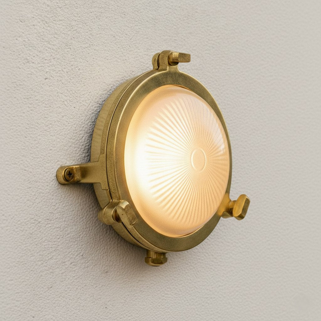 Round brass bulkhead light with a frosted glass diffuser