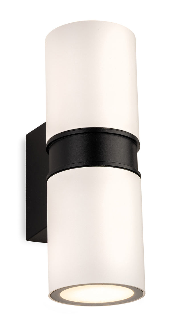 White cylindrical wall light with black band and base, emitting light from the bottom