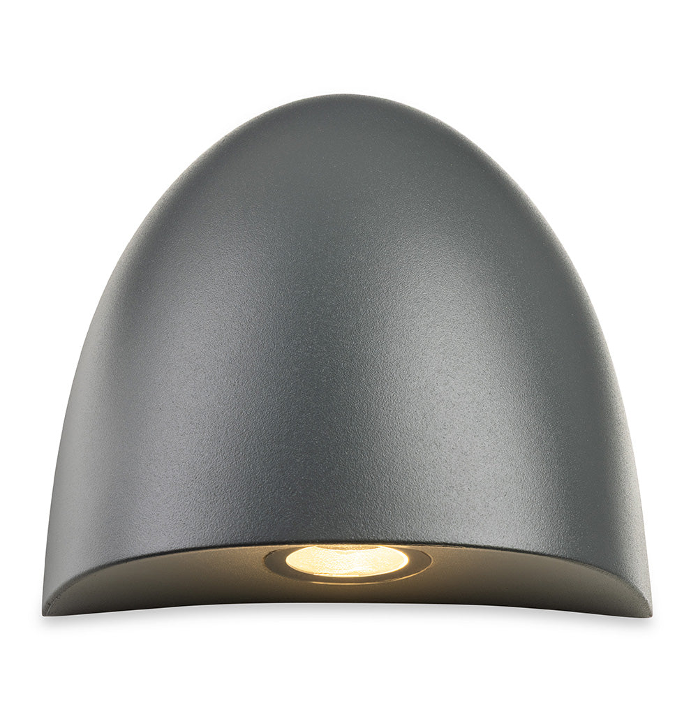 Dark grey half-dome wall light with a single warm light shining downwards