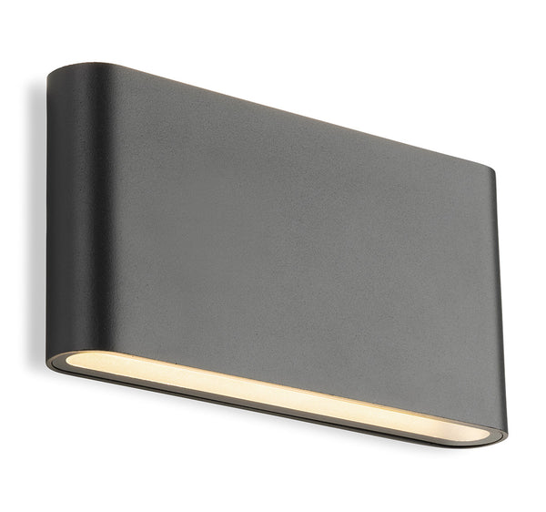 Dark grey rectangular outdoor wall light with rounded edges and warm light shining from the bottom
