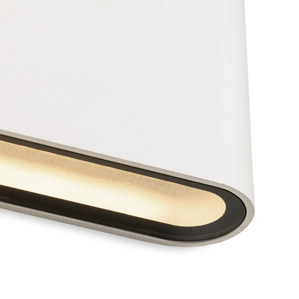 Close up of a white wall light with a horizontal strip of warm light