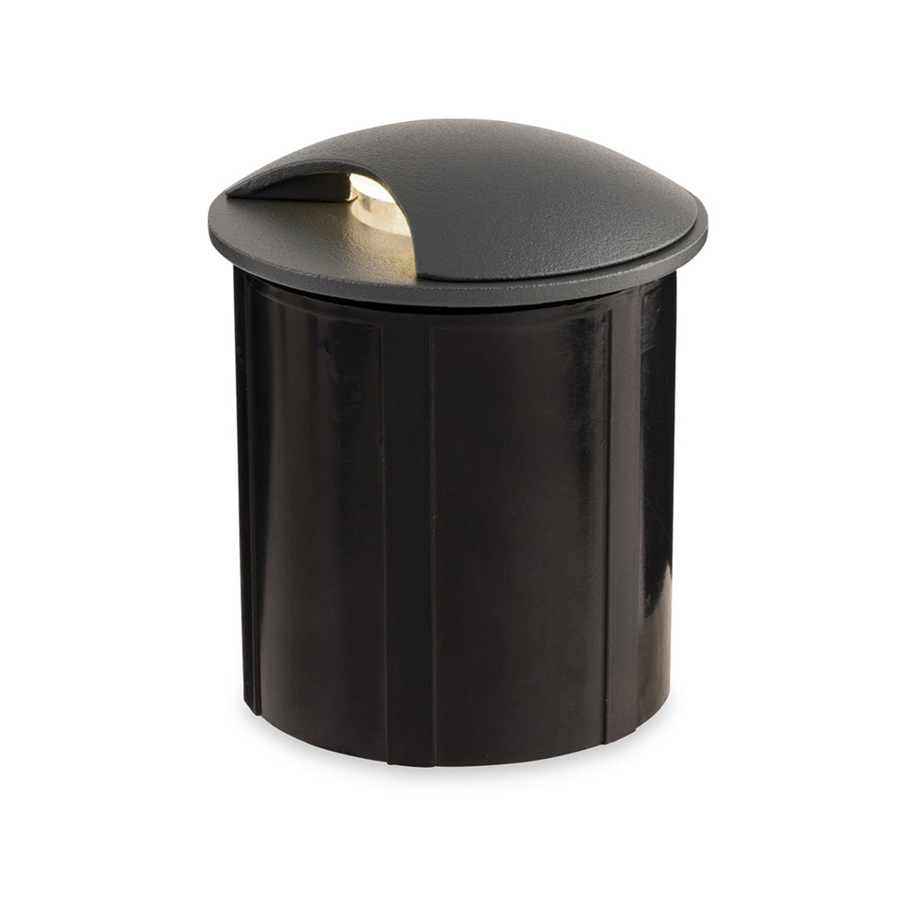 Black cylindrical ground light with a curved top and a small light opening