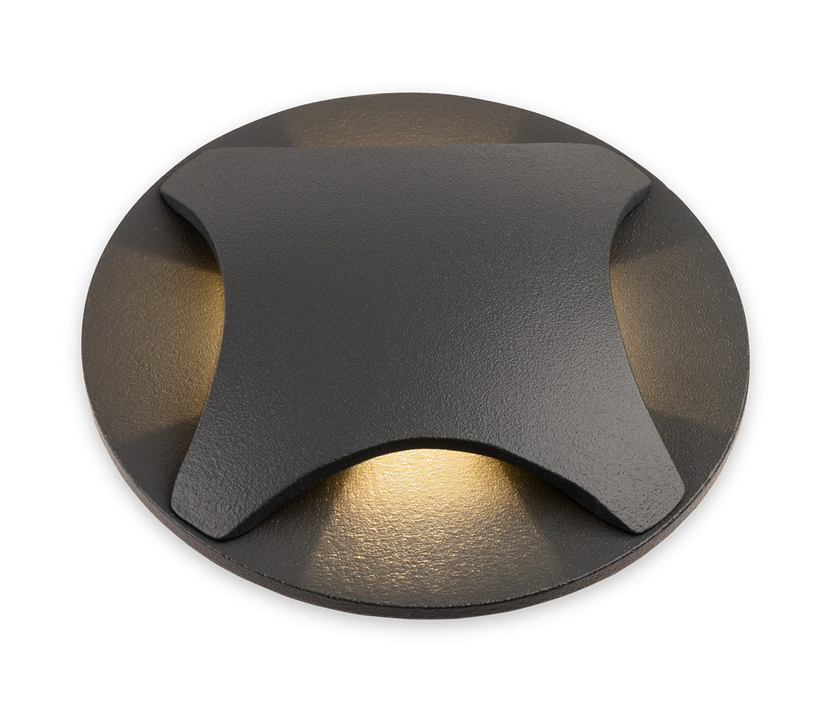 Round black outdoor light with four light beams pointing outwards