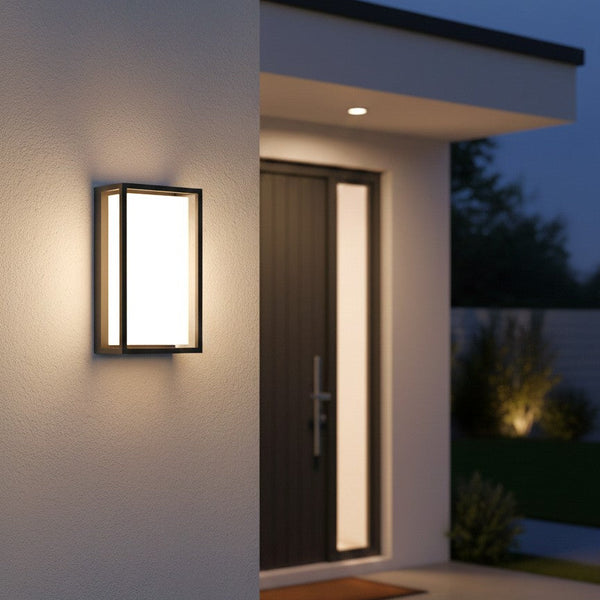 Rectangular outdoor wall light with a black frame and a white diffuser, illuminating a modern house entrance