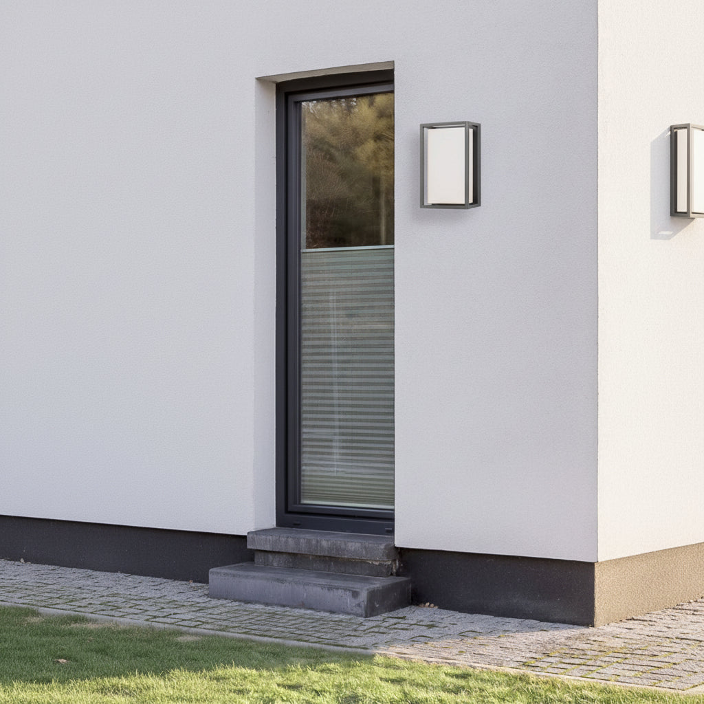 Modern outdoor wall light on a white building next to a glass door with steps