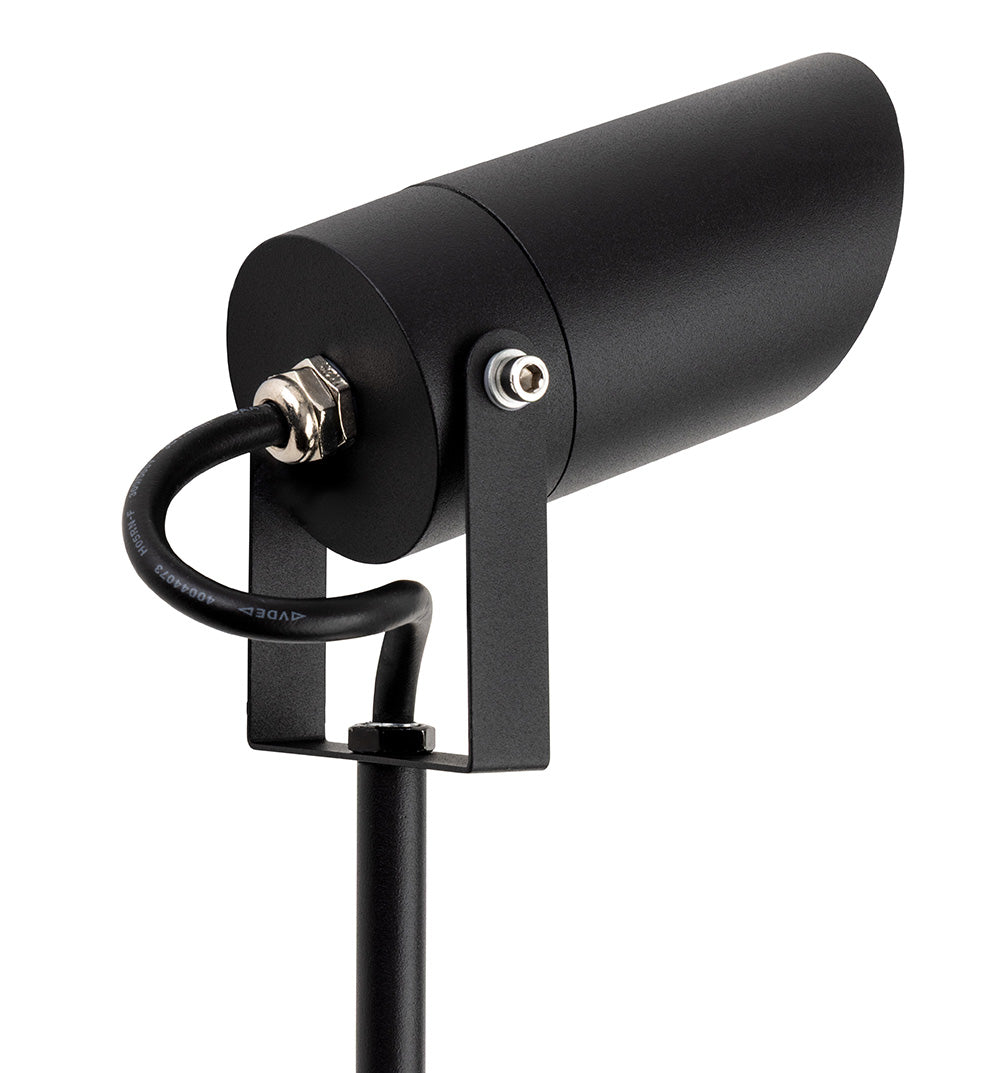 Black outdoor spotlight with a cylindrical head and a sturdy base