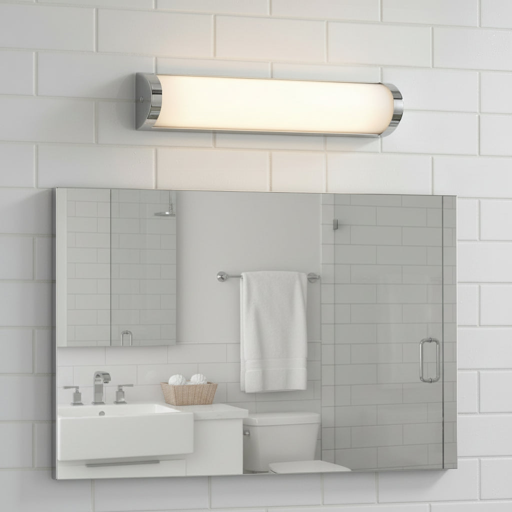 Bathroom with white subway tile, chrome light fixture, large mirror, white vanity, and toilet