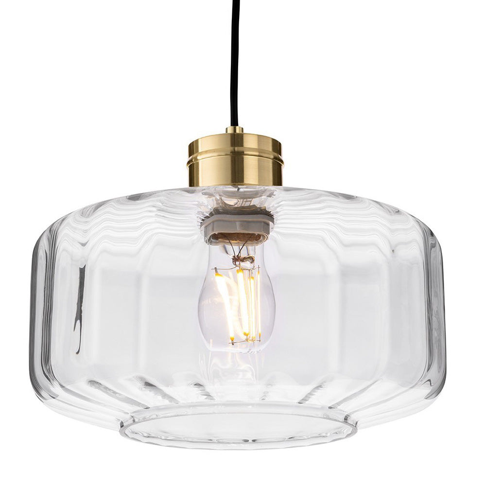 Clear glass pendant light with a brass fitting and an exposed filament bulb