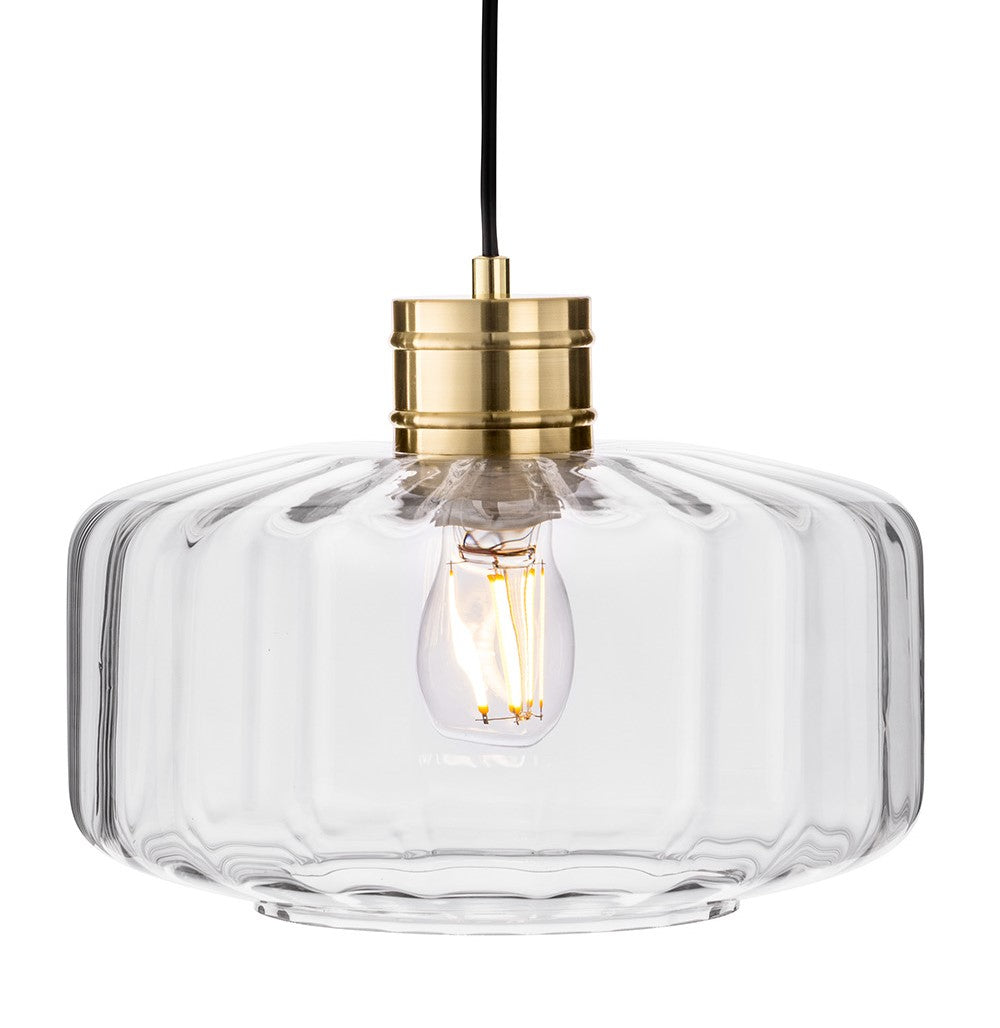 Fluted glass pendant light with a brass fixture and exposed filament bulb
