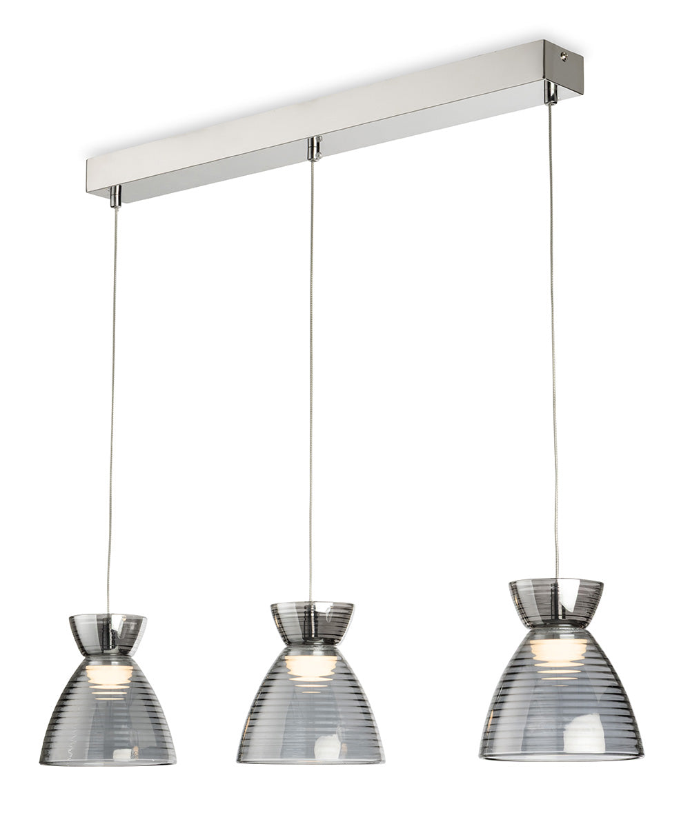 Three pendant lights with ribbed glass shades hang from a chrome bar
