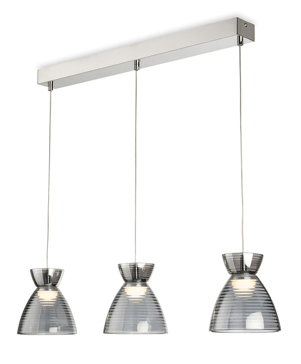 Three pendant lights with ribbed glass shades hang from a chrome bar