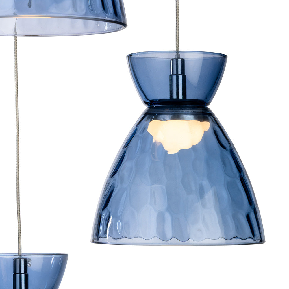 Blue glass pendant light with textured surface and illuminated bulb
