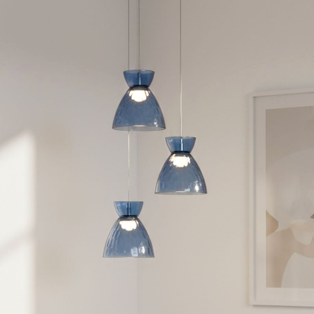 Three blue glass pendant lights hanging from the ceiling, with a framed picture on the wall