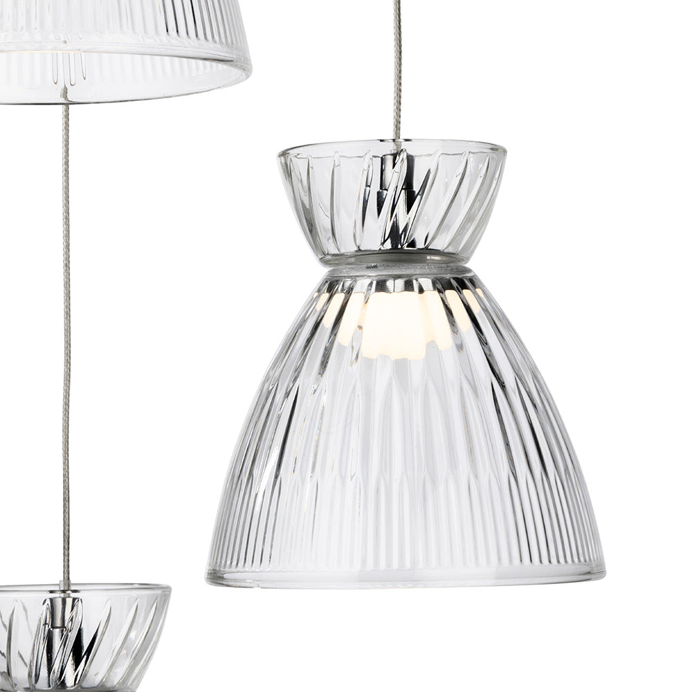 Close up of a clear glass pendant light with vertical ridges
