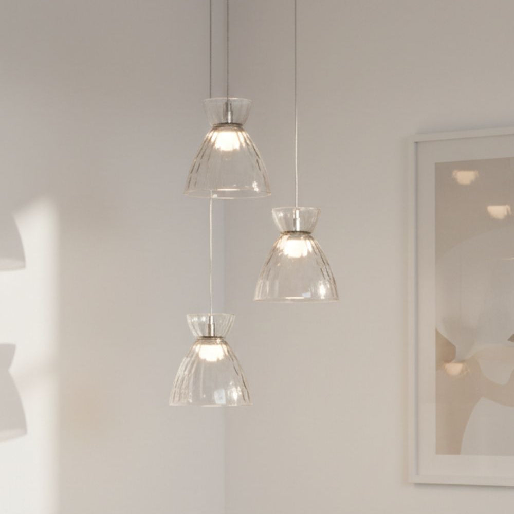 Three clear glass pendant lights with textured shades hanging from the ceiling
