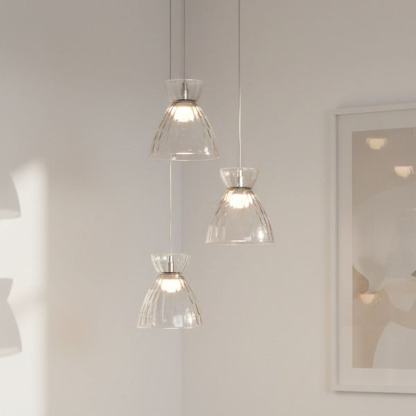Three clear glass pendant lights with textured shades hanging from the ceiling