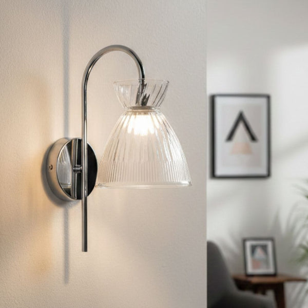 Chrome wall light with a clear ribbed glass shade