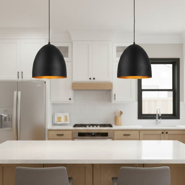 Two black and gold pendant lights hanging above a kitchen island