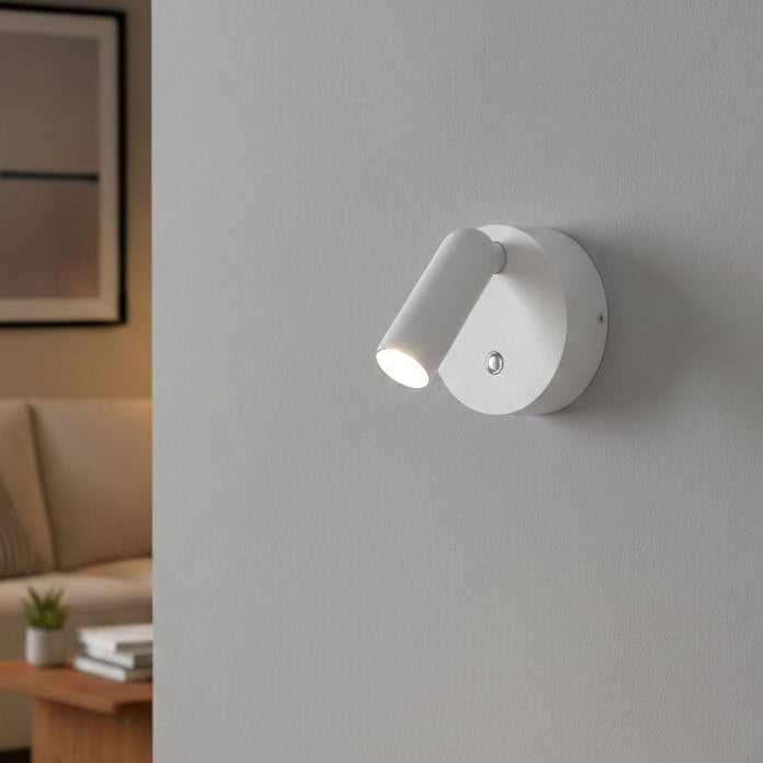 White wall-mounted spotlight with an adjustable head, illuminating a light grey wall