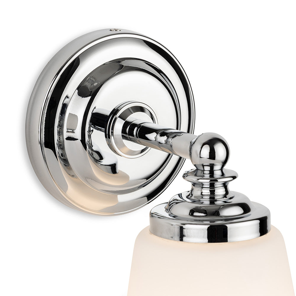 Chrome wall sconce with a frosted glass shade