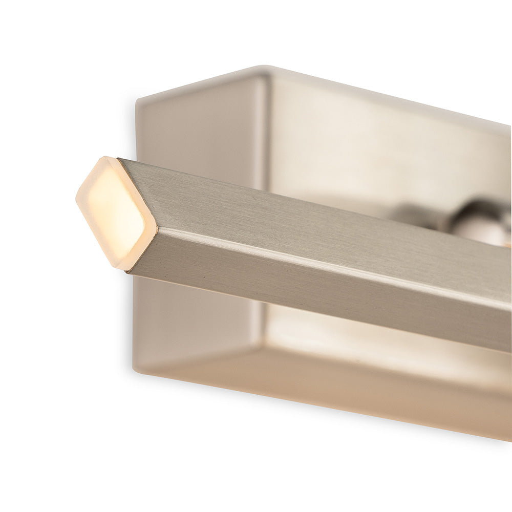 Close up of a brushed nickel light fixture with a glowing square light at the end