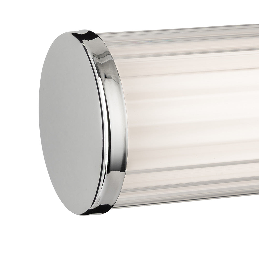 Close up of a chrome end cap on a ribbed glass light fixture