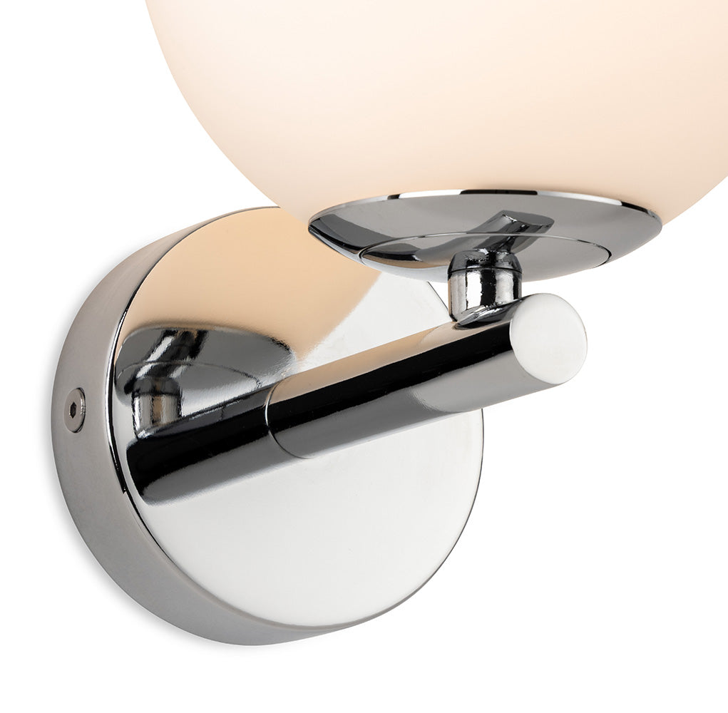 Chrome wall light with a round frosted glass shade