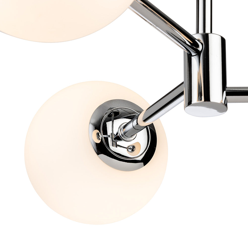 Close up of a chrome light fixture with white spherical bulbs