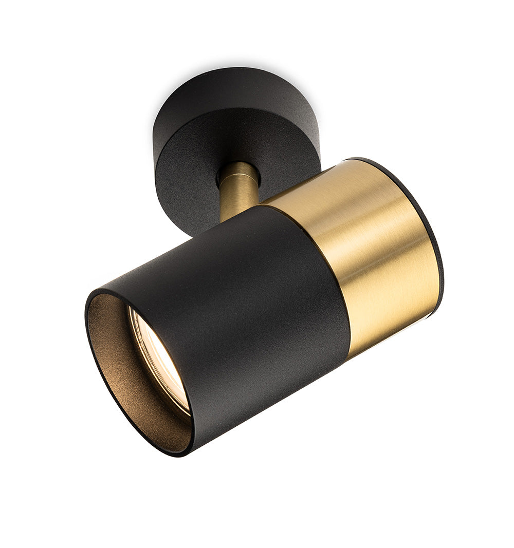 Black and gold ceiling spotlight with a cylindrical head and a round base