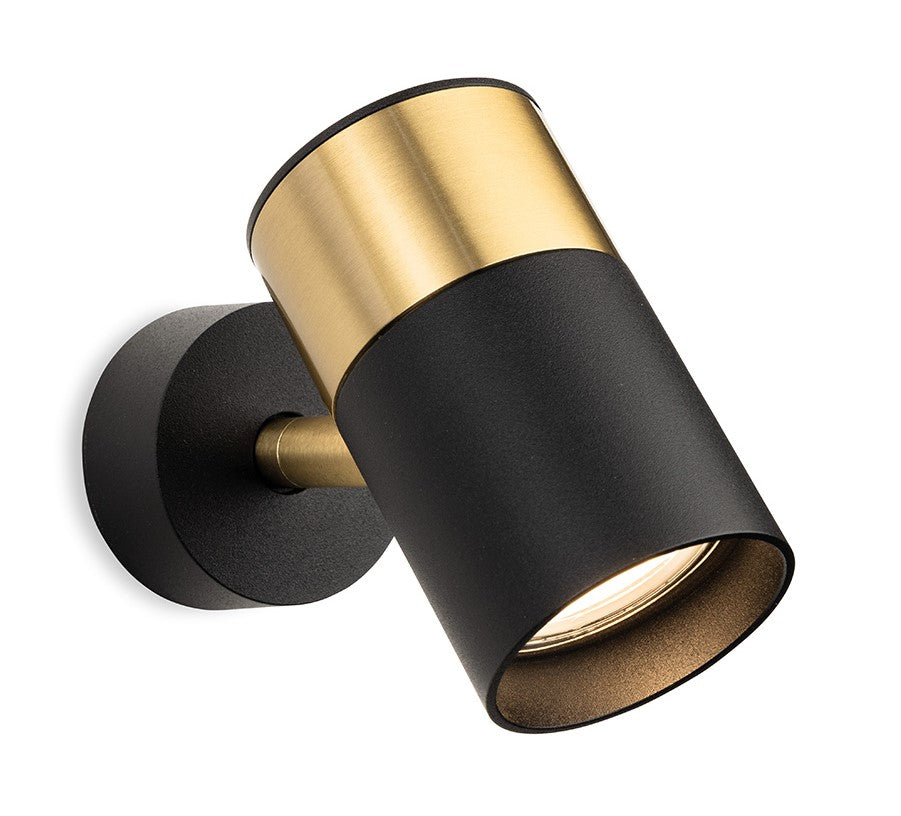 Black and gold cylindrical wall light with a bright bulb