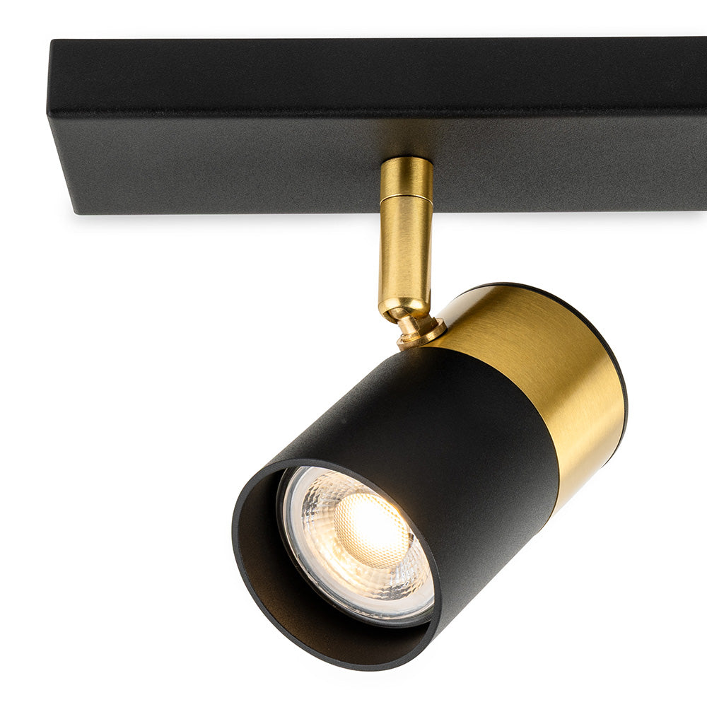 Black and gold ceiling spotlight with a warm light