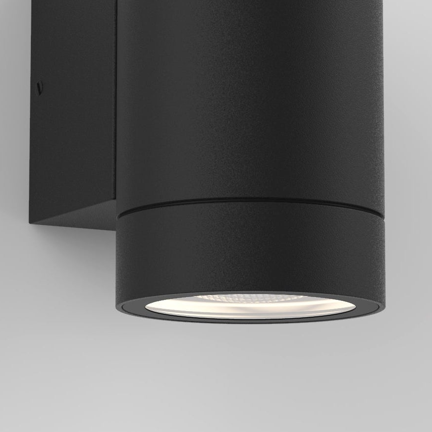 Black cylindrical outdoor wall light with a textured finish, emitting light downwards